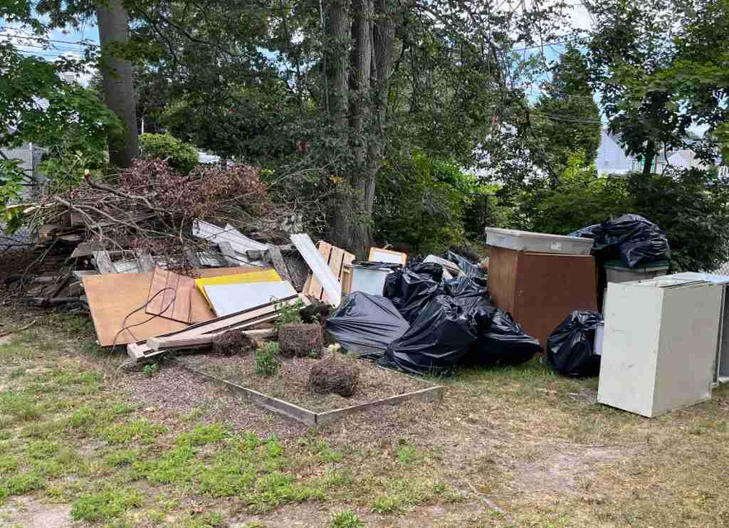 Pile of household junk being loaded for removal on Long Island